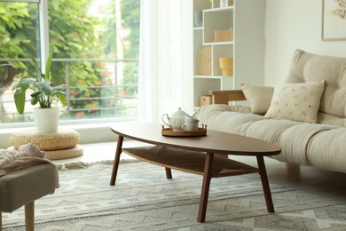 Photo of Coffee table, sofa and decor in dining room. Interior design