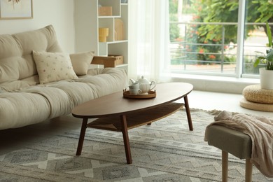 Photo of Coffee table, sofa and decor in dining room. Interior design