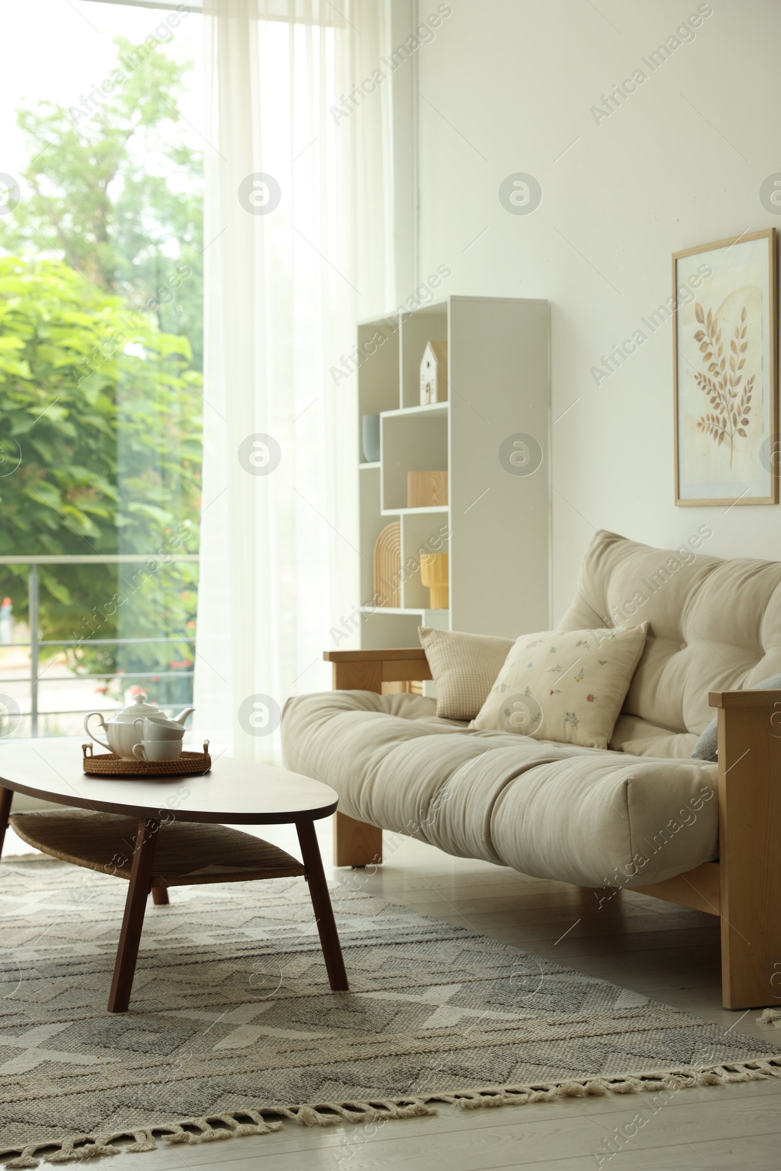 Photo of Coffee table, sofa and decor in dining room. Interior design