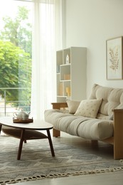Photo of Coffee table, sofa and decor in dining room. Interior design