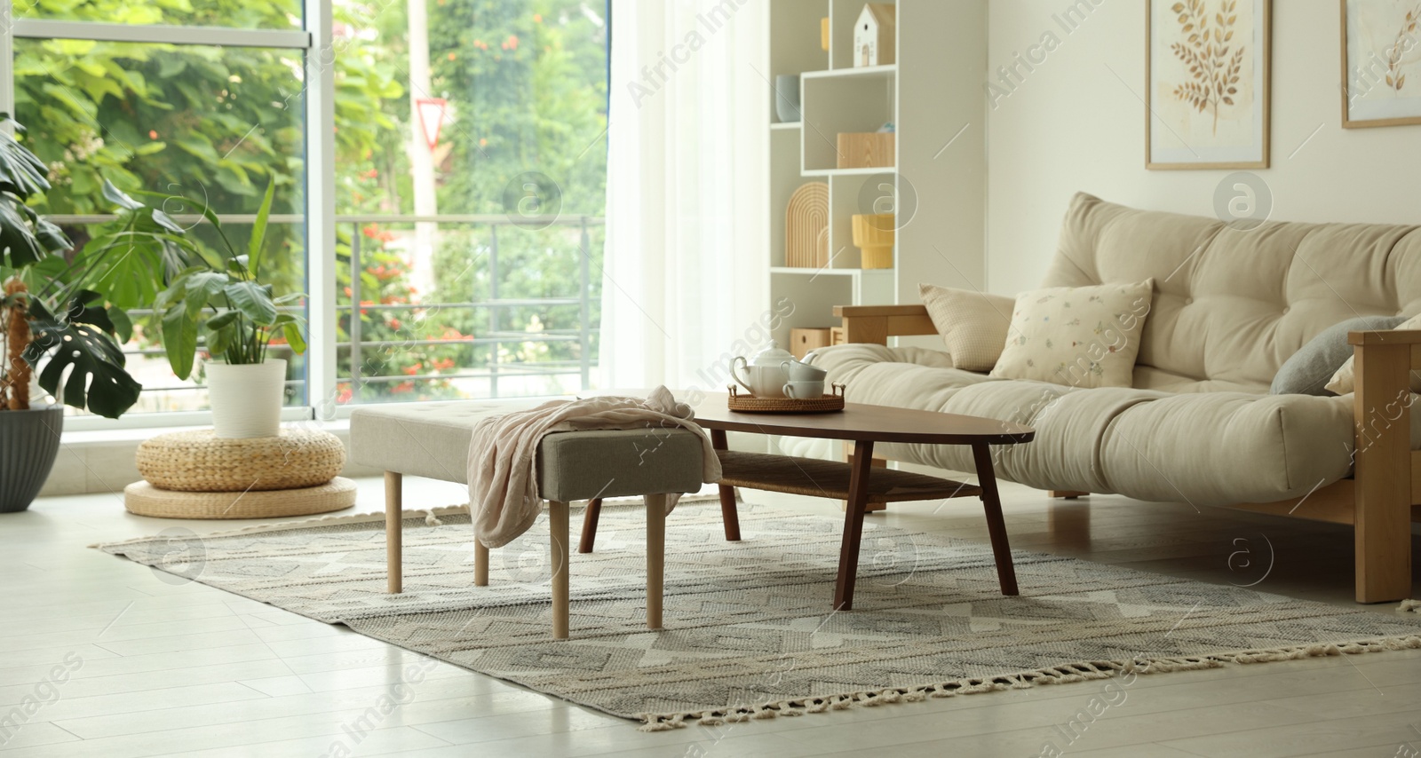 Coffee table, sofa, bench and decor in dining room. Interior design Photo of Coffee table, sofa, bench and decor in dining room. Interior design