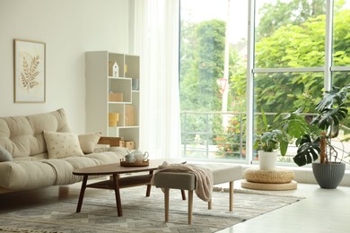 Photo of Coffee table, sofa, bench and decor in dining room. Interior design