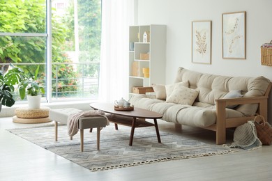 Photo of Coffee table, sofa, bench and decor in dining room. Interior design