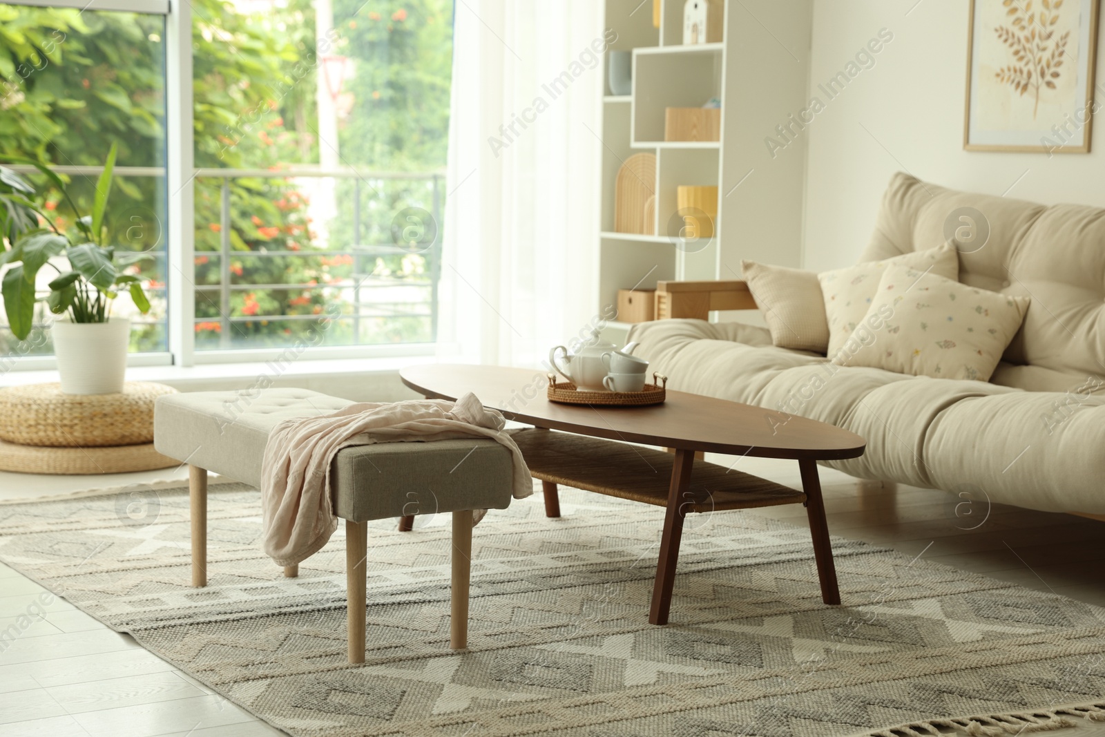 Coffee table, sofa, bench and decor in dining room. Interior design Photo of Coffee table, sofa, bench and decor in dining room. Interior design