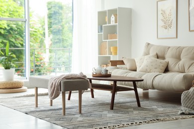 Photo of Coffee table, sofa, bench and decor in dining room. Interior design