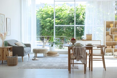 Photo of Beautiful table setting, chairs and decor in dining room. Interior design
