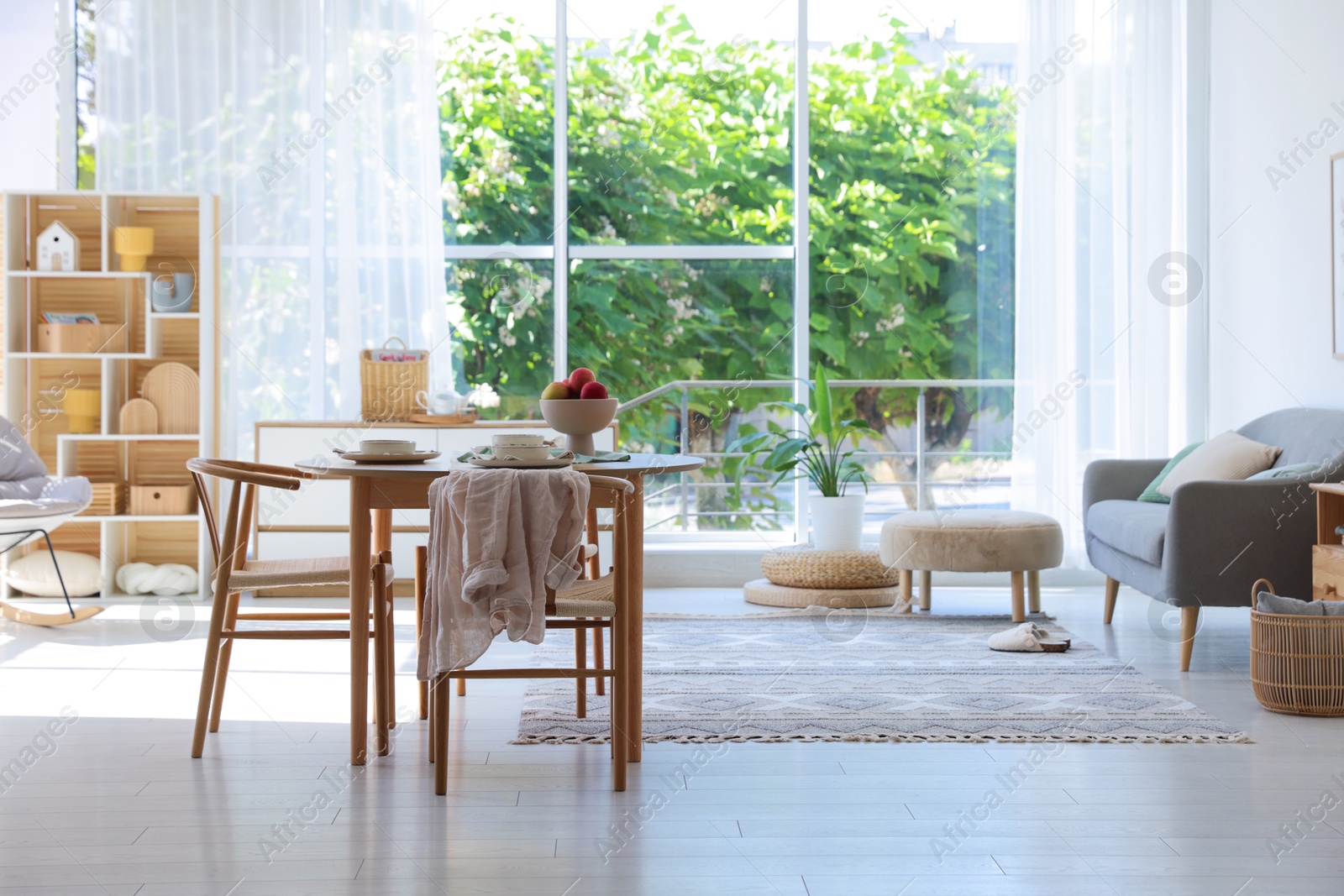 Beautiful table setting, chairs and decor in dining room. Interior design Photo of Beautiful table setting, chairs and decor in dining room. Interior design