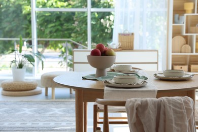 Photo of Stylish table setting with fresh fruits and decor in dining room. Interior design