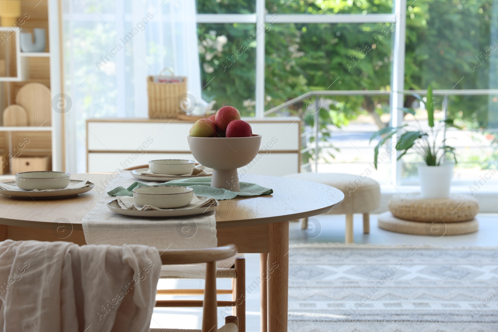 Photo of Stylish table setting with fresh fruits and decor in dining room. Interior design