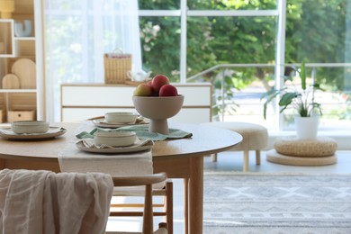 Photo of Stylish table setting with fresh fruits and decor in dining room. Interior design