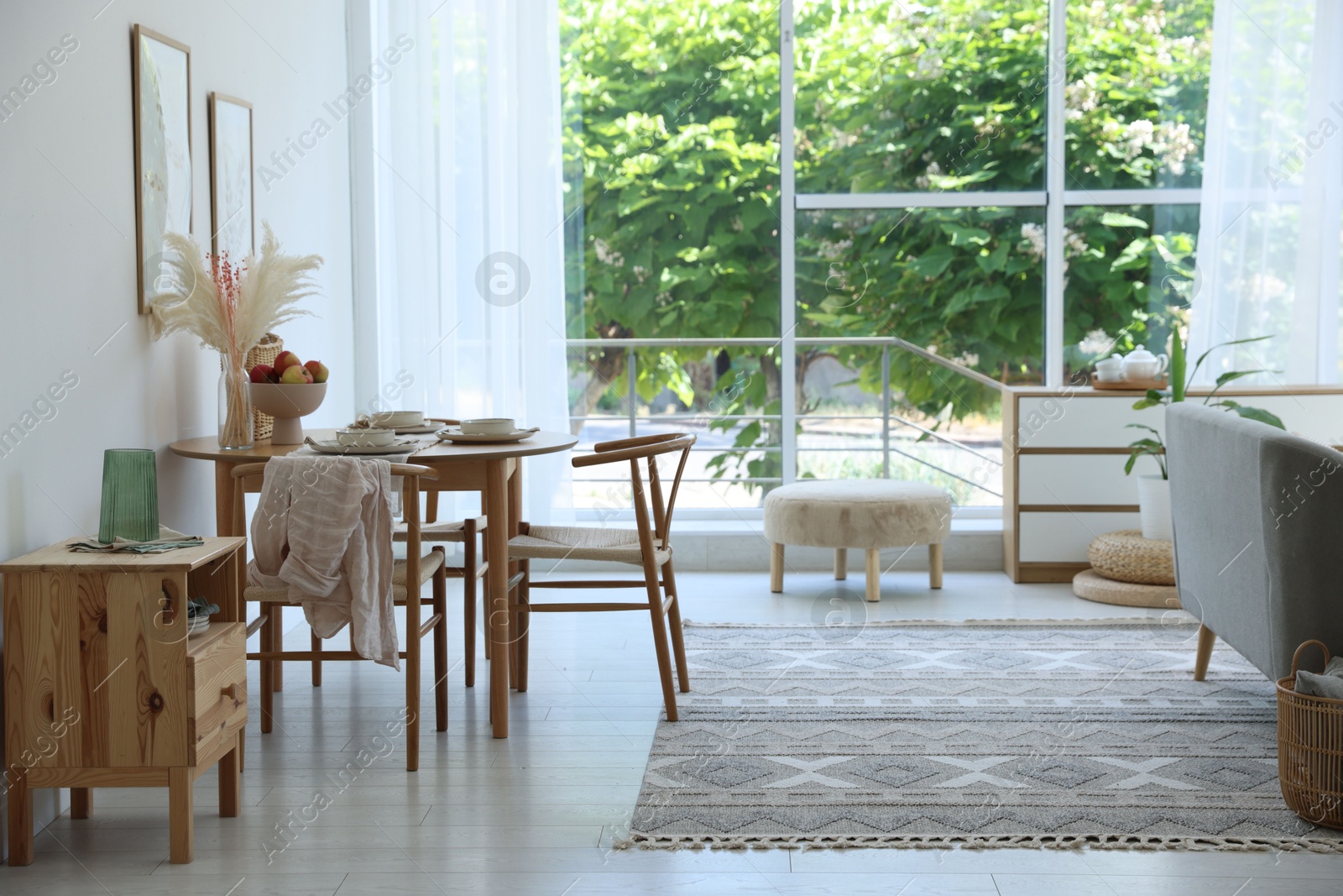 Stylish table setting, chairs and decor in dining room. Interior design Photo of Stylish table setting, chairs and decor in dining room. Interior design