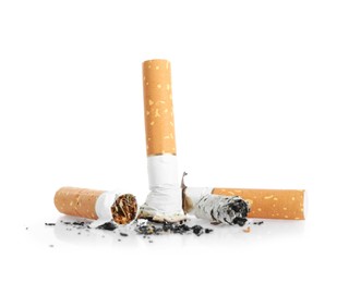 Photo of Cigarette butts with ash isolated on white