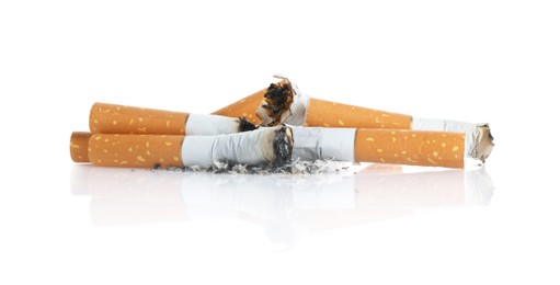 Photo of Cigarette butts with ash isolated on white
