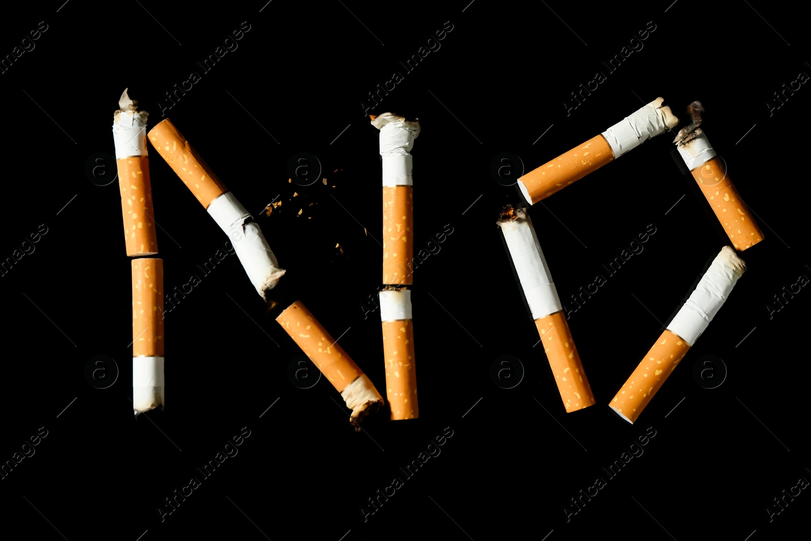 Word NO made with cigarette butts on black background, top view Photo of Word NO made with cigarette butts on black background, top view
