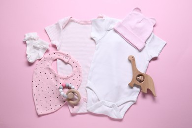 Photo of Baby clothes and accessories on pink background, flat lay
