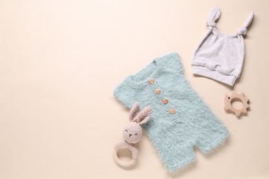 Photo of Baby clothes and accessories on beige background, flat lay. Space for text