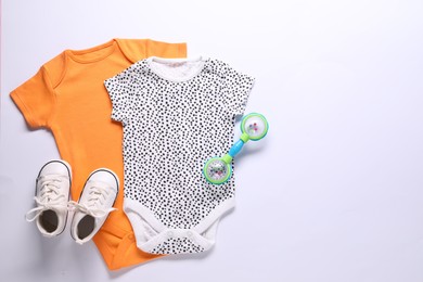 Photo of Baby clothes and accessory on white background, flat lay. Space for text