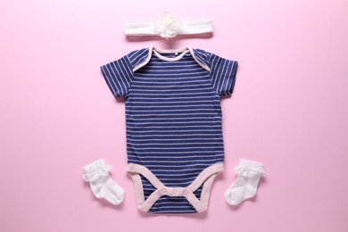 Photo of Baby clothes and accessories on pink background, flat lay