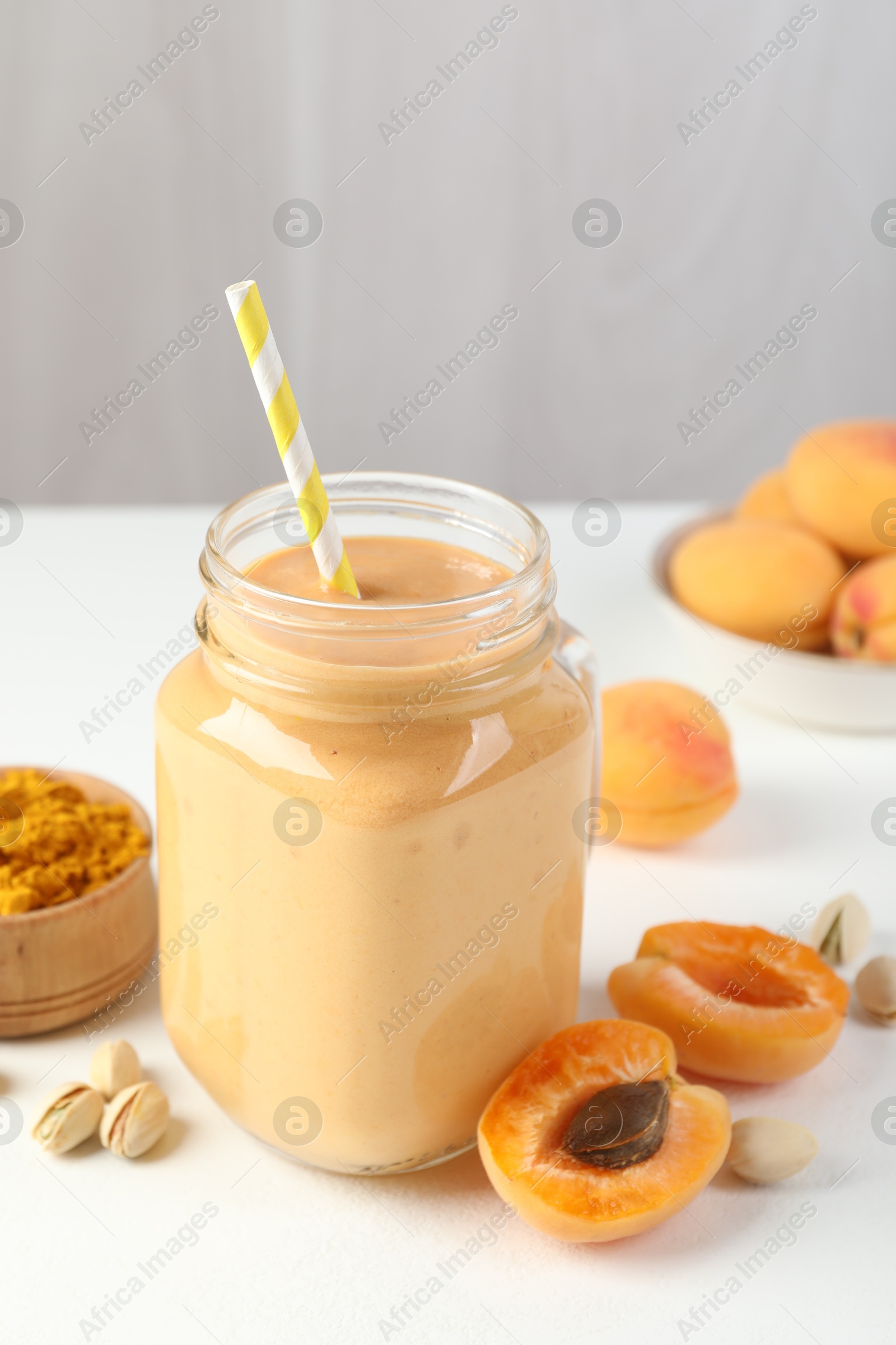 Superfood. Tasty smoothie and ingredients on white table, closeup Photo of Superfood. Tasty smoothie and ingredients on white table, closeup
