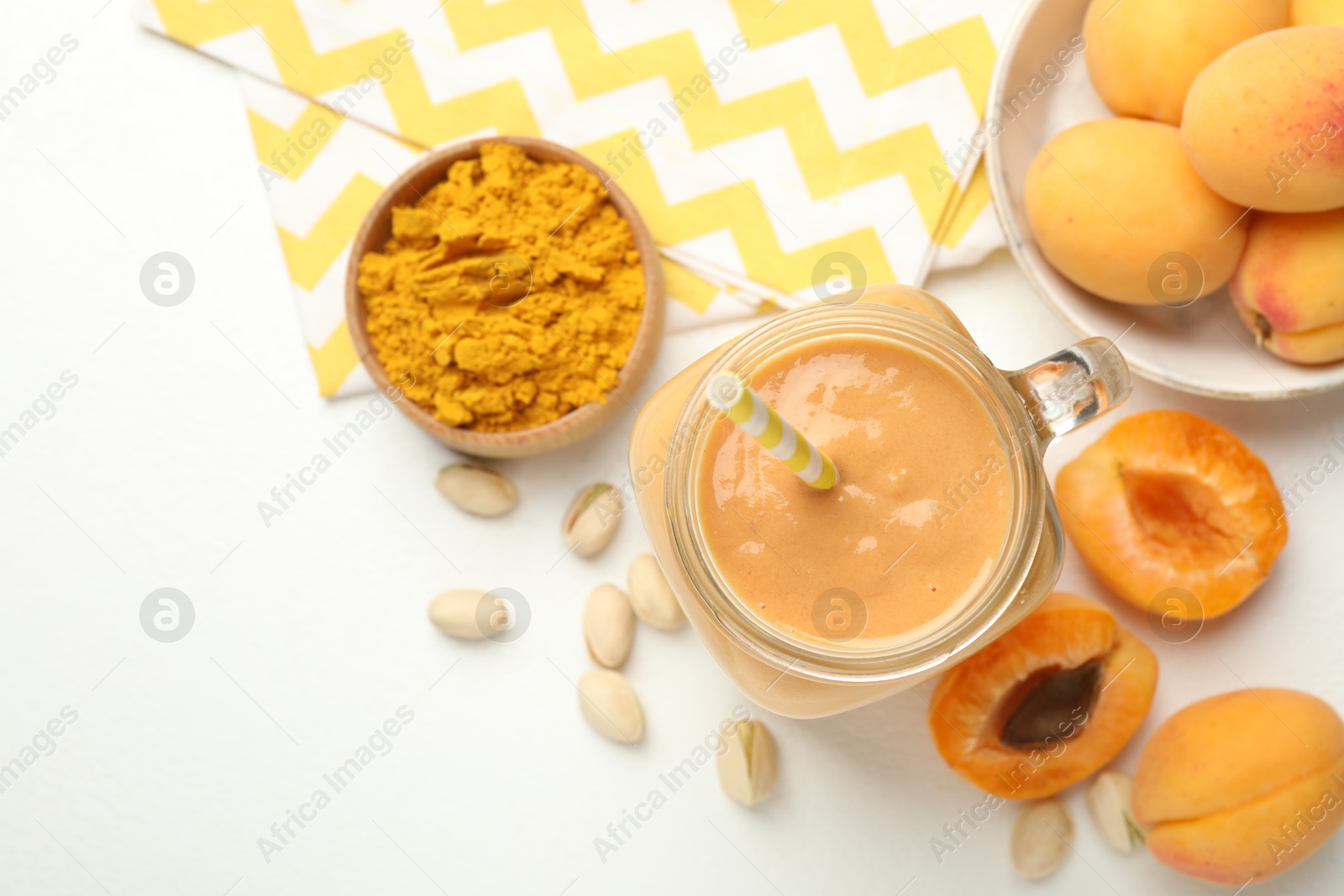 Superfood. Tasty smoothie and ingredients on white table, flat lay. Space for text Photo of Superfood. Tasty smoothie and ingredients on white table, flat lay. Space for text
