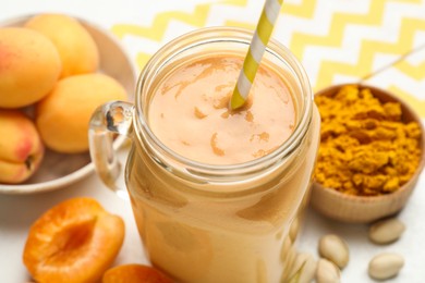 Photo of Superfood. Tasty smoothie and ingredients on table, closeup