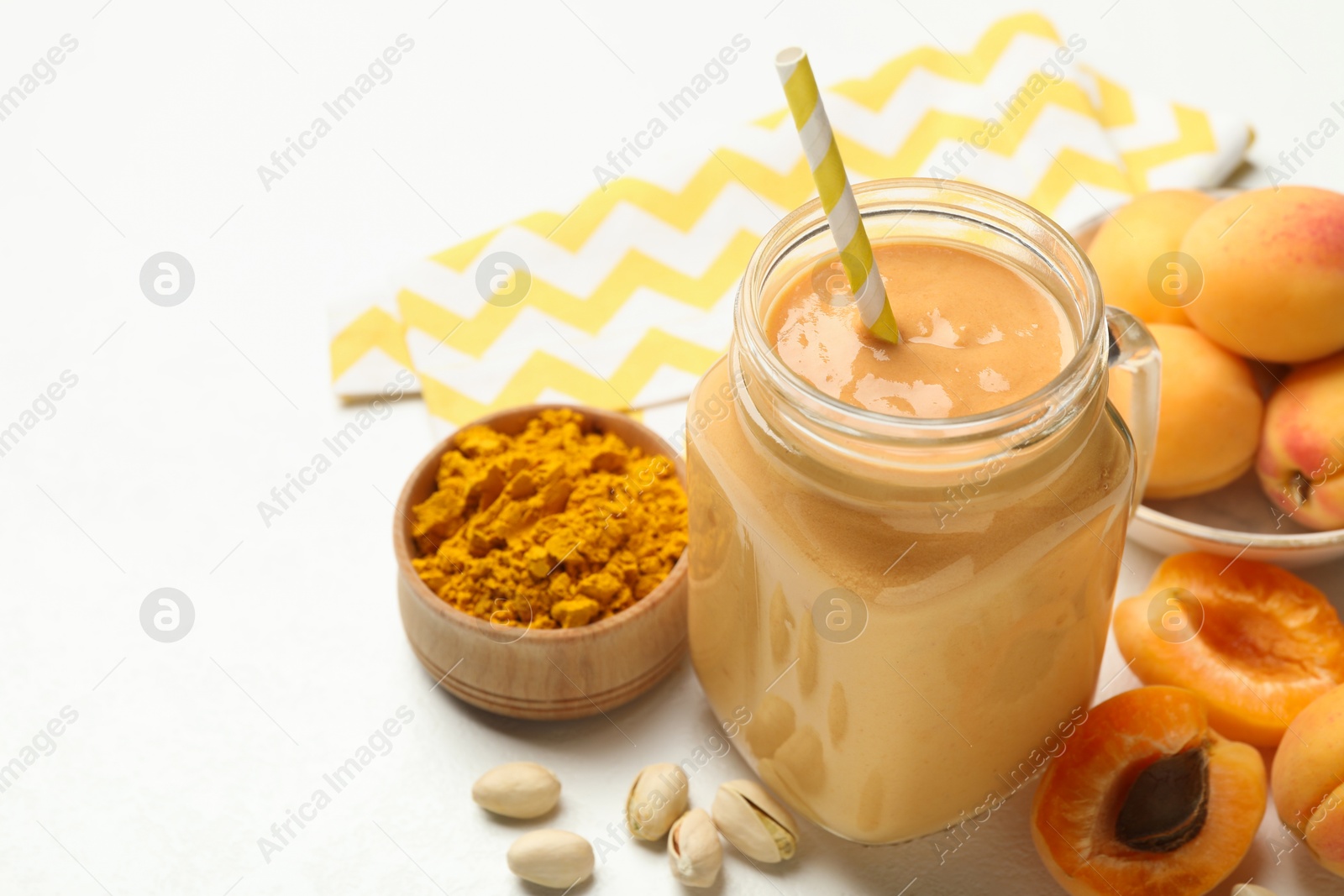 Superfood. Tasty smoothie and ingredients on white table, closeup. Space for text Photo of Superfood. Tasty smoothie and ingredients on white table, closeup. Space for text