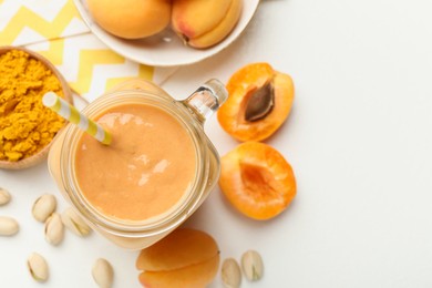 Photo of Superfood. Tasty smoothie and ingredients on white table, flat lay. Space for text