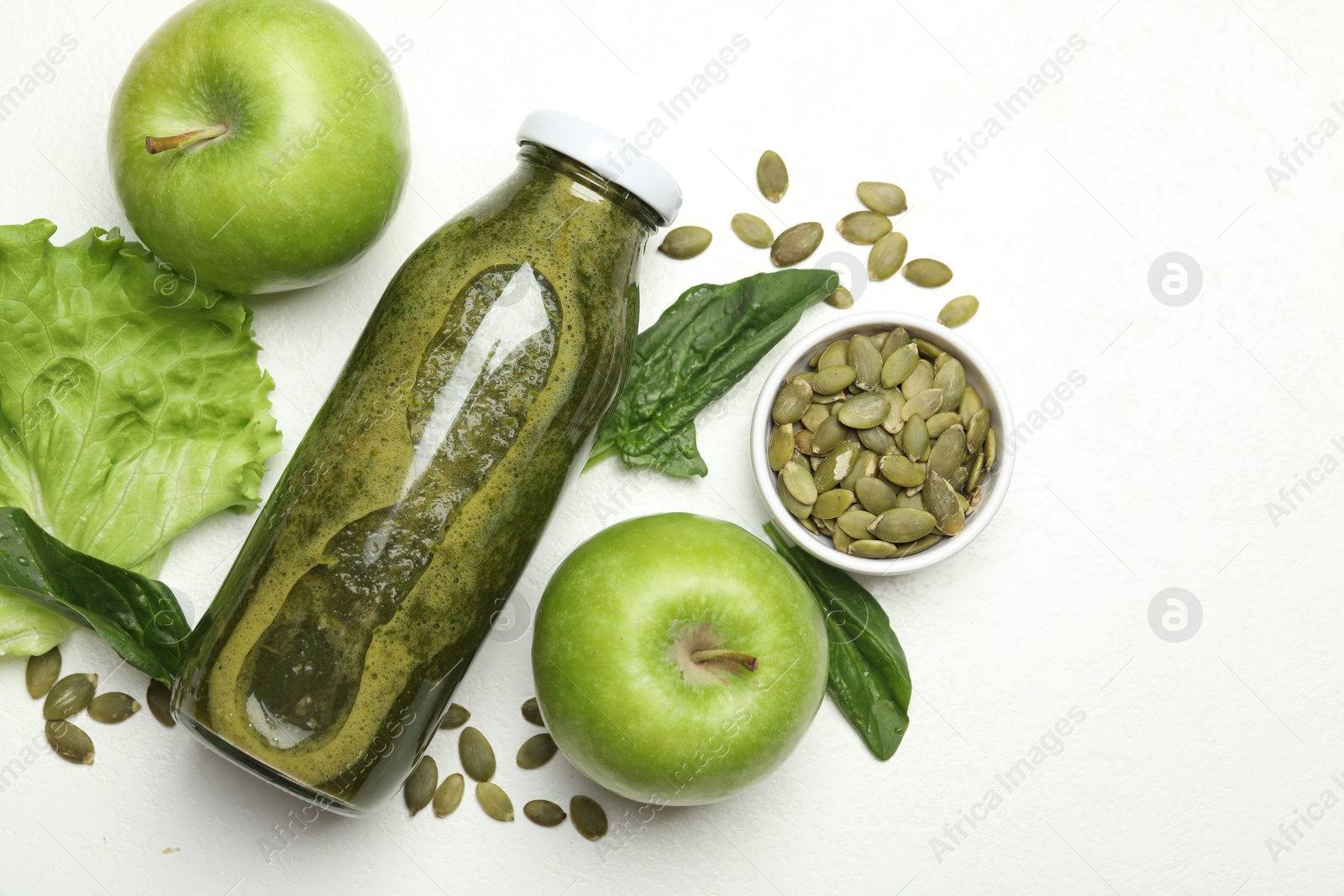 Superfood. Tasty smoothie in glass bottle and ingredients on white table, flat lay Photo of Superfood. Tasty smoothie in glass bottle and ingredients on white table, flat lay