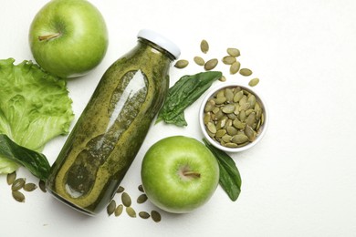 Photo of Superfood. Tasty smoothie in glass bottle and ingredients on white table, flat lay