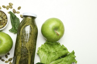 Photo of Superfood. Tasty smoothie in glass bottle and ingredients on white table, flat lay. Space for text