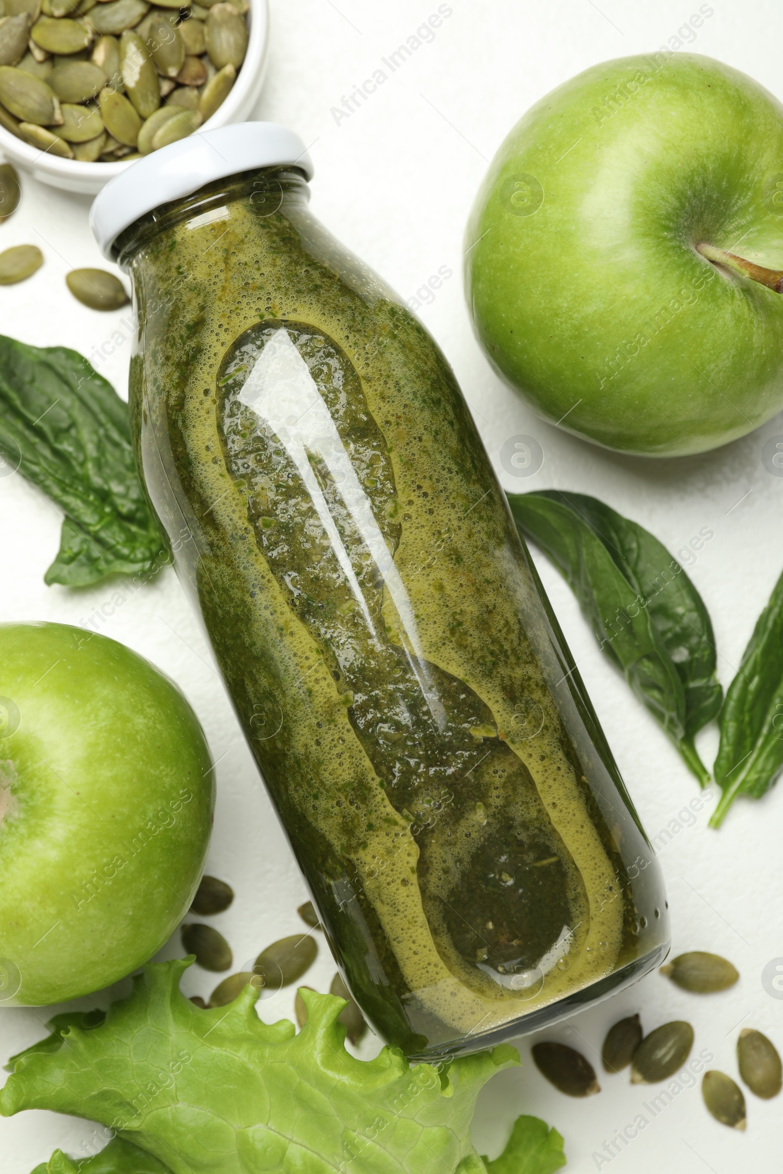 Superfood. Tasty smoothie in glass bottle and ingredients on white table, flat lay Photo of Superfood. Tasty smoothie in glass bottle and ingredients on white table, flat lay