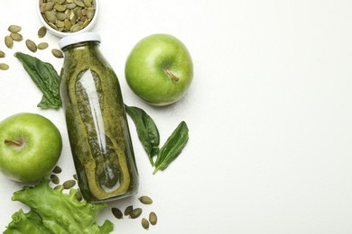 Photo of Superfood. Tasty smoothie in glass bottle and ingredients on white table, flat lay. Space for text