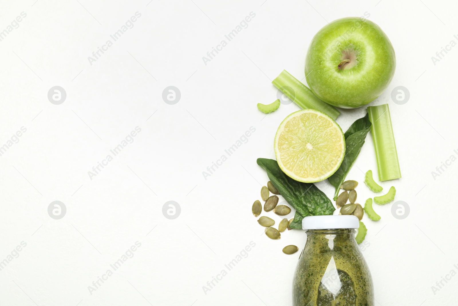 Superfood. Tasty smoothie in glass bottle and ingredients on white table, flat lay. Space for text Photo of Superfood. Tasty smoothie in glass bottle and ingredients on white table, flat lay. Space for text