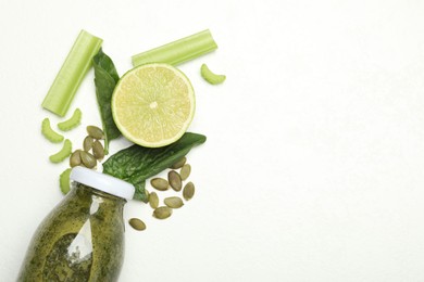 Photo of Superfood. Tasty smoothie in glass bottle and ingredients on white table, flat lay. Space for text