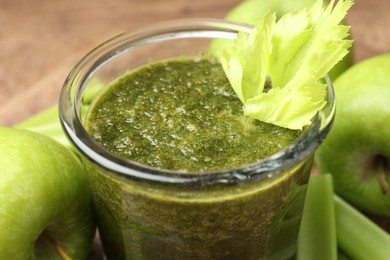Photo of Superfood. Tasty smoothie in glass and ingredients on table, closeup