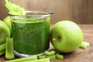 Photo of Superfood. Tasty smoothie in glass and ingredients on wooden table, closeup