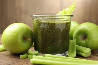 Photo of Superfood. Tasty smoothie in glass and ingredients on wooden table, closeup