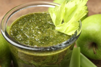 Photo of Superfood. Tasty smoothie in glass and ingredients on table, closeup