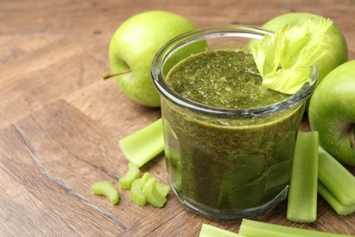 Photo of Superfood. Tasty smoothie in glass and ingredients on wooden table, closeup. Space for text