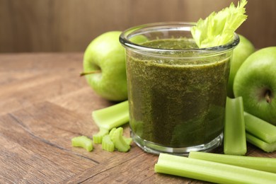 Photo of Superfood. Tasty smoothie in glass and ingredients on wooden table, closeup. Space for text