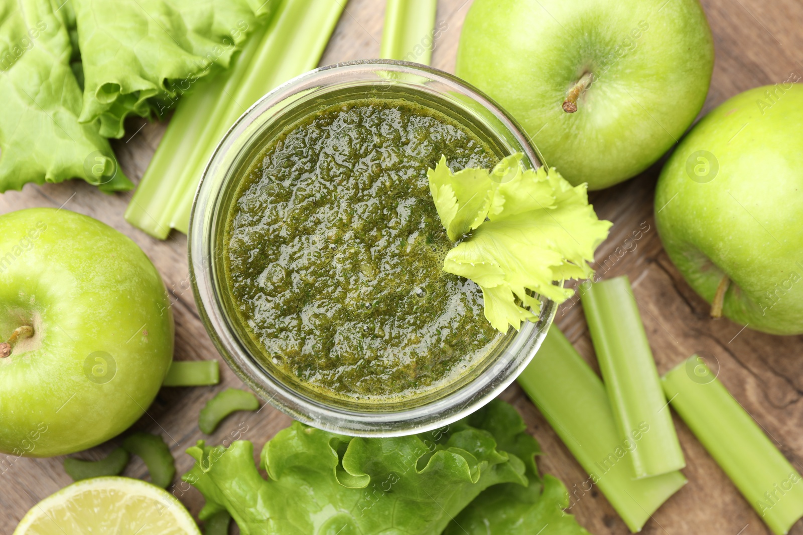 Superfood. Tasty smoothie in glass and ingredients on wooden table, flat lay Photo of Superfood. Tasty smoothie in glass and ingredients on wooden table, flat lay