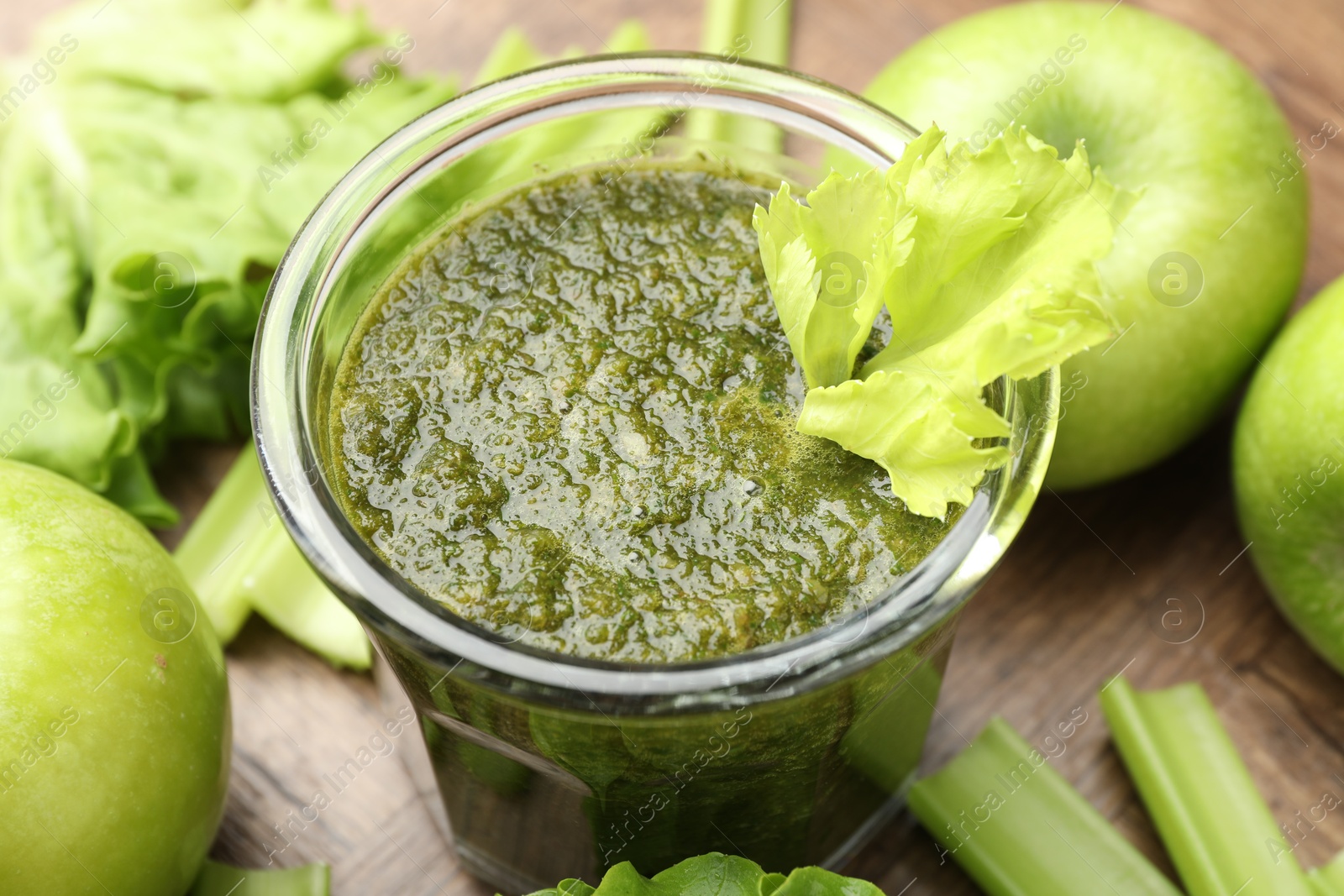 Superfood. Tasty smoothie in glass and ingredients on wooden table, closeup Photo of Superfood. Tasty smoothie in glass and ingredients on wooden table, closeup