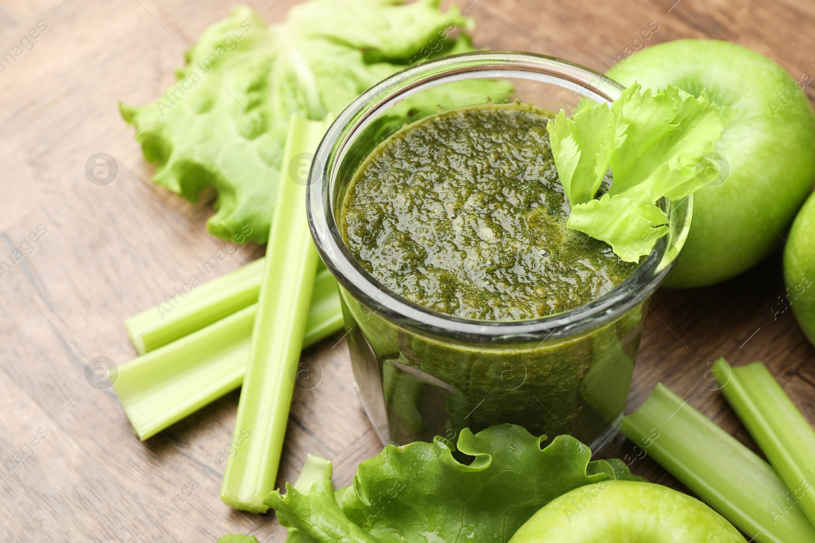 Superfood. Tasty smoothie in glass and ingredients on wooden table, closeup Photo of Superfood. Tasty smoothie in glass and ingredients on wooden table, closeup