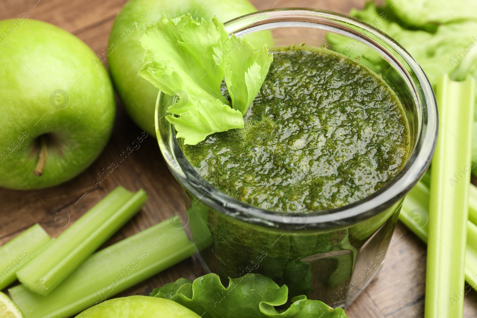 Superfood. Tasty smoothie in glass and ingredients on wooden table, closeup Photo of Superfood. Tasty smoothie in glass and ingredients on wooden table, closeup
