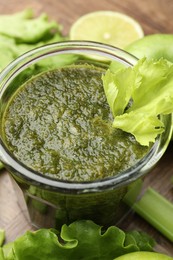 Photo of Superfood. Tasty smoothie in glass and ingredients on table, closeup