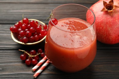 Photo of Superfood. Tasty smoothie in glass and ingredients on wooden table, closeup