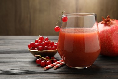 Photo of Superfood. Tasty smoothie in glass and ingredients on wooden table, closeup. Space for text