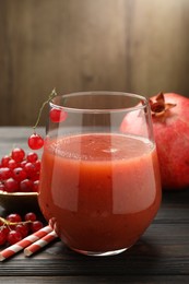 Photo of Superfood. Tasty smoothie in glass and ingredients on wooden table, closeup