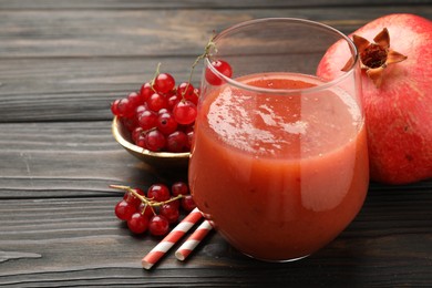 Photo of Superfood. Tasty smoothie in glass and ingredients on wooden table, closeup. Space for text