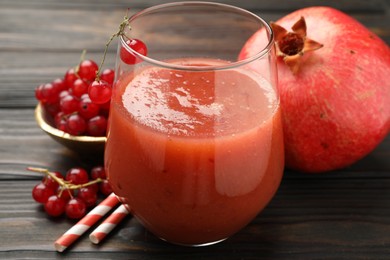 Photo of Superfood. Tasty smoothie in glass and ingredients on wooden table, closeup